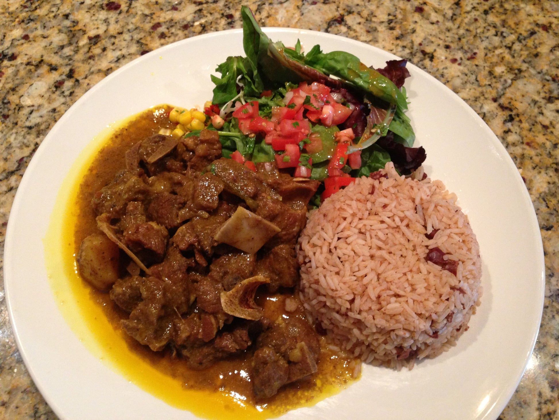 Curry goat with rice and peas